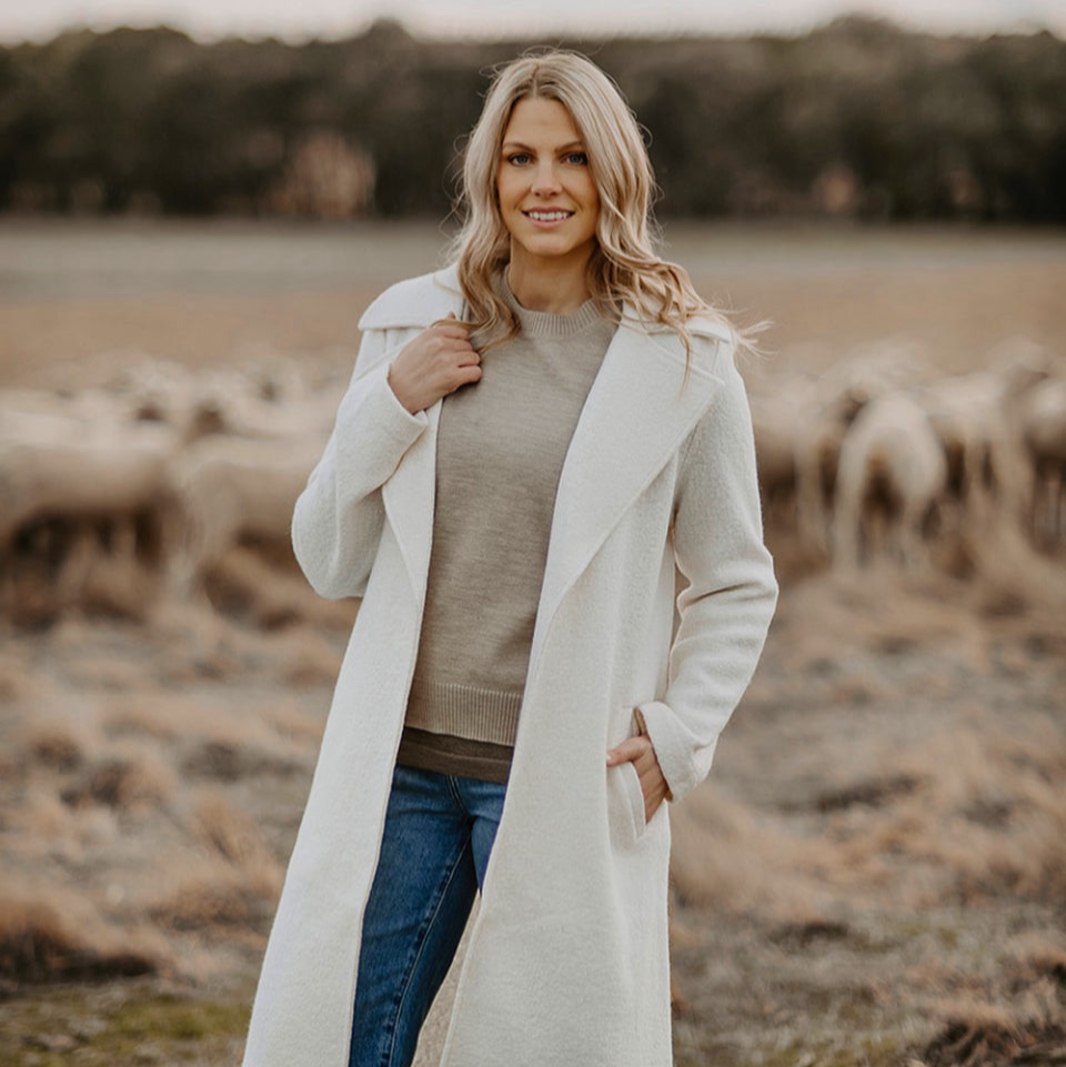 Woman wearing the Fields Victoria Long Wool Jacket in winter white