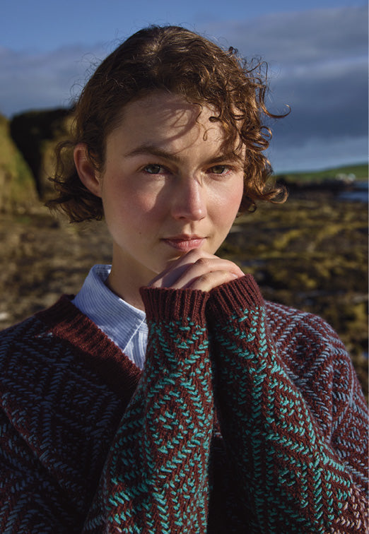 Woman wearing the Fisherman Tapestry Vee Lambswool Cardigan in Cinnamon Spice
