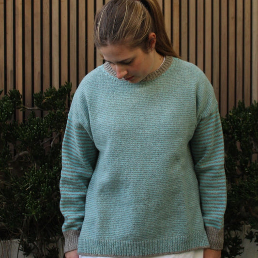 Woman wearing the Fisherman Out Of Ireland Striped Crew Jumper in Aqua and Mushroom