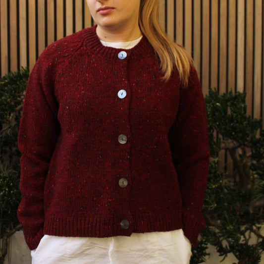 Woman wearing the Fisherman out of Ireland Raglan Merino Cardigan in Cranberry red