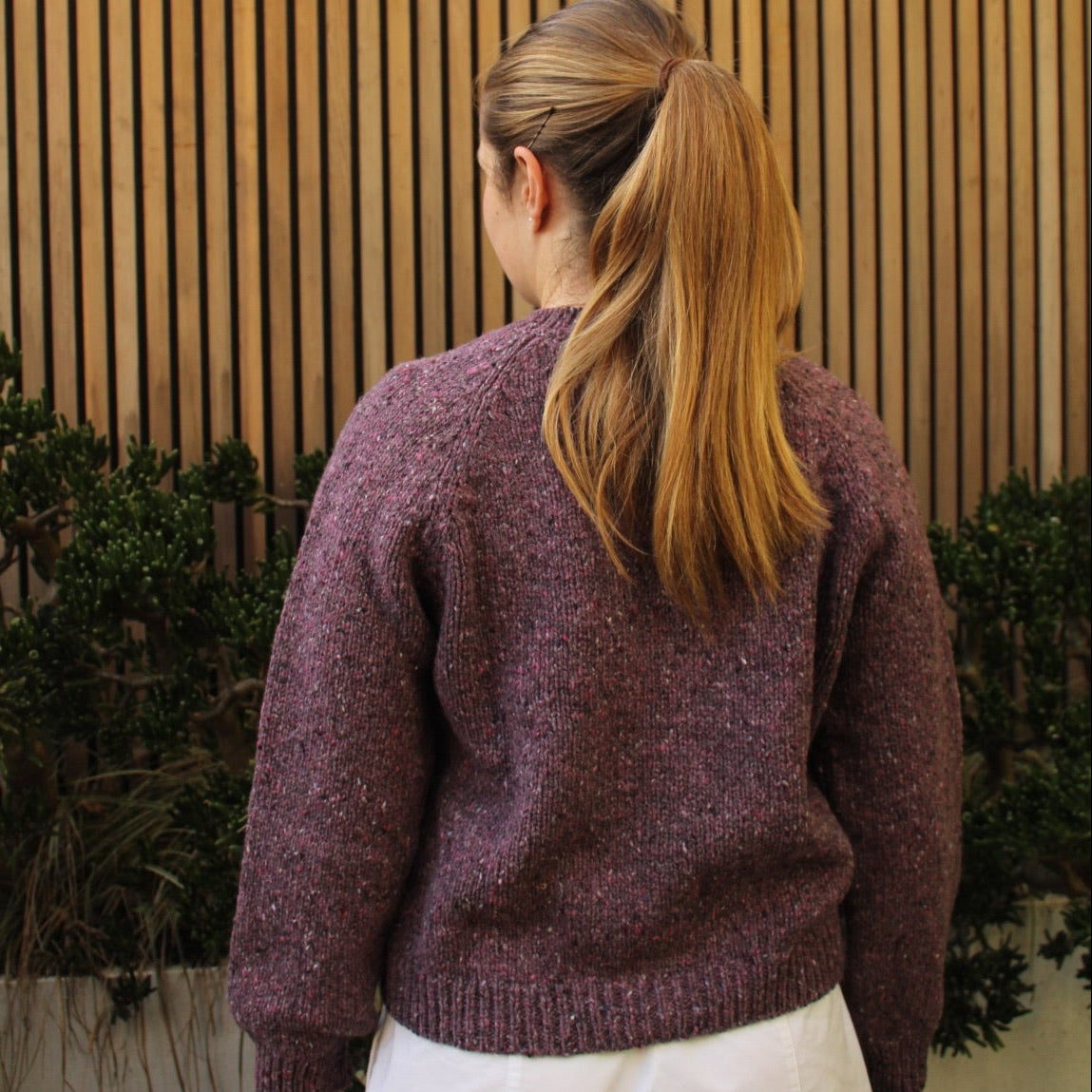 Woman wearing the Fisherman out of Ireland Cropped Raglan Merino Cardigan in Mauve