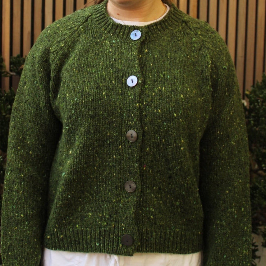 Woman wearing the Fisherman out of Ireland Raglan Merino Cardigan in Shamrock green