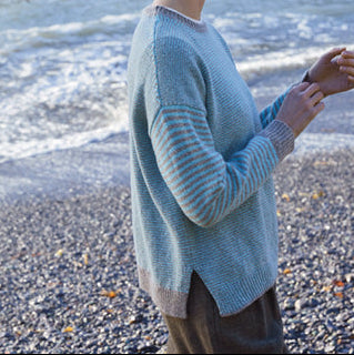 Woman wearing the Fisherman Out Of Ireland Stripe Crew Jumper in Mushroom and Aqua