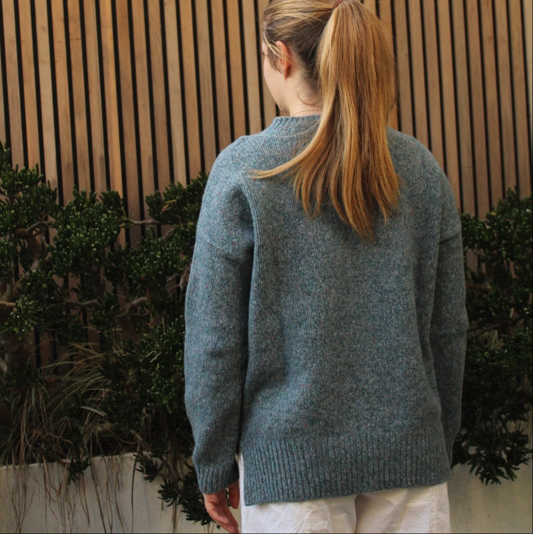 Woman wearing the Fisherman out of Ireland Dropped Shoulder Crew Jumper in blue smoke