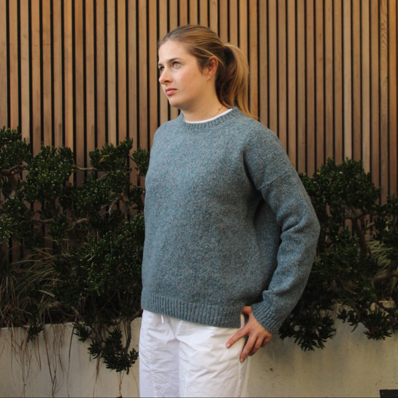 Woman wearing the Fisherman out of Ireland Dropped Shoulder Crew Jumper in blue smoke
