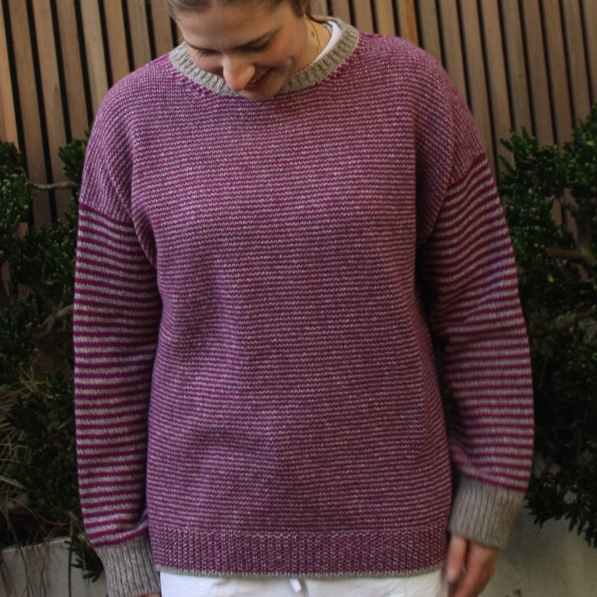 Woman wearing the Fisherman Out Of Ireland Striped Crew Jumper in Mushroom and Foxglove