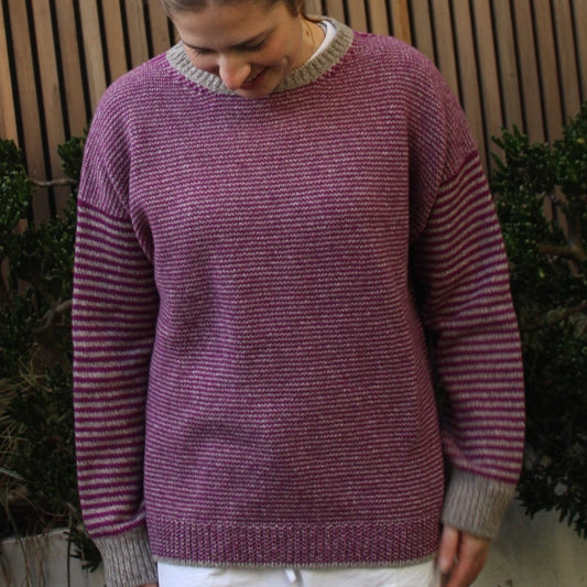 Woman wearing the Fisherman Out Of Ireland Striped Crew Jumper in Mushroom and Foxglove