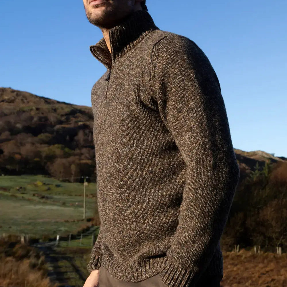 Man wearing the Fisherman out of ireland quarter zip merino wool sweater in peat  brown
