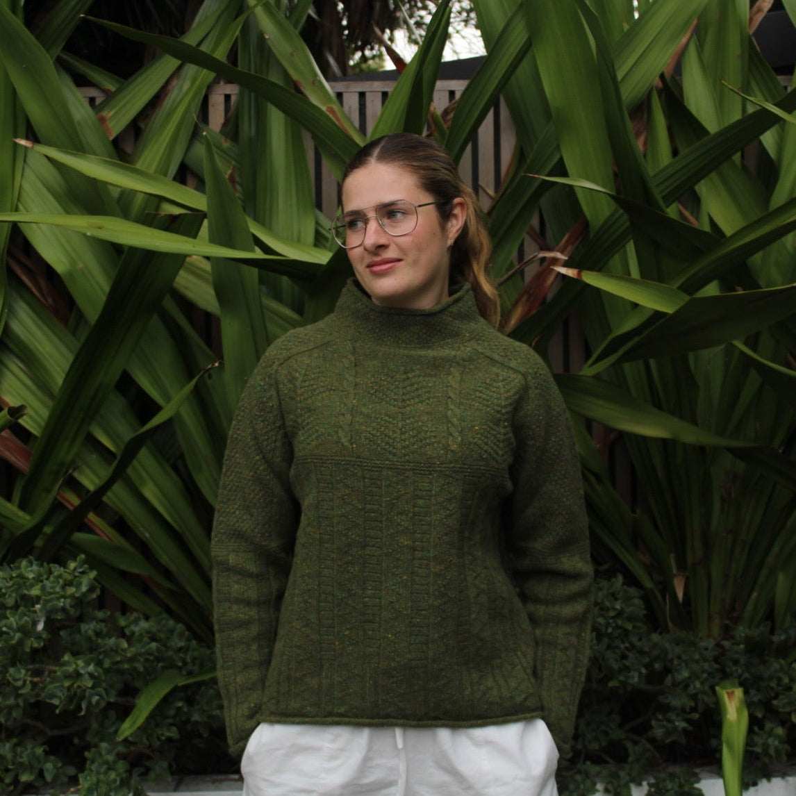 Woman wearing the Aran Tunic sweater by Harley of Scotland in Raasay green