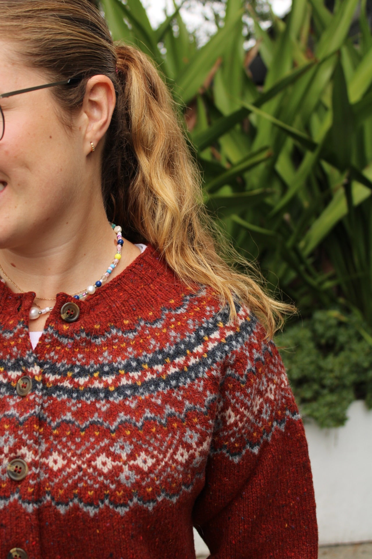 Close up of the Fairisle knitted pattern on the yoke in red