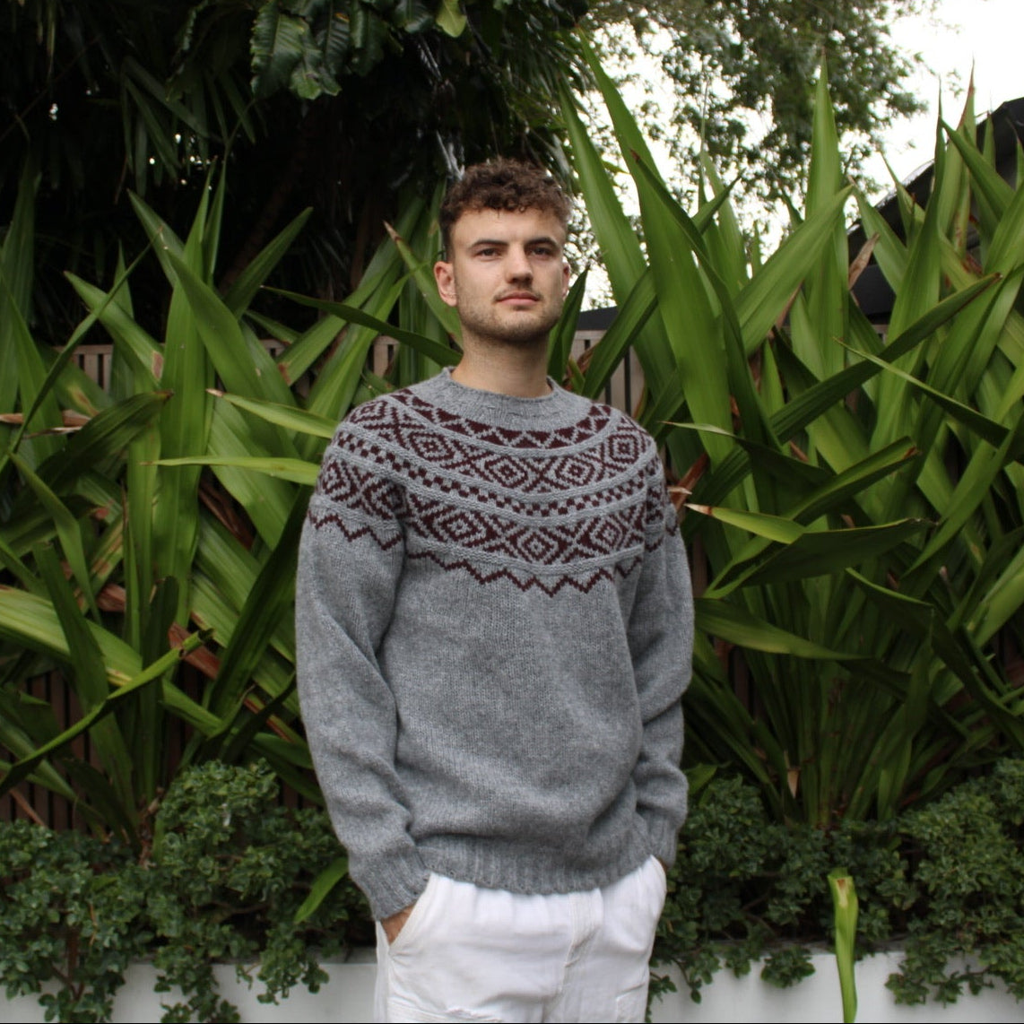 Man wearing the Shetland wool Fairisle Sweater in grey and beetroot by Harley of Scotland
