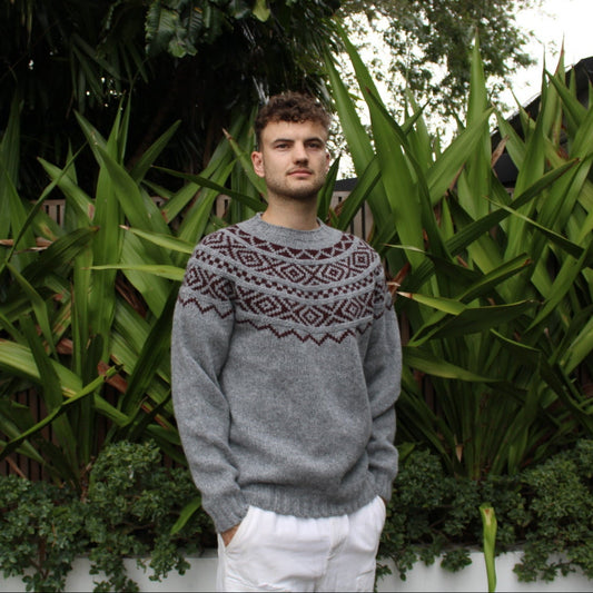 Man wearing the Shetland wool Fairisle Sweater in grey and beetroot by Harley of Scotland