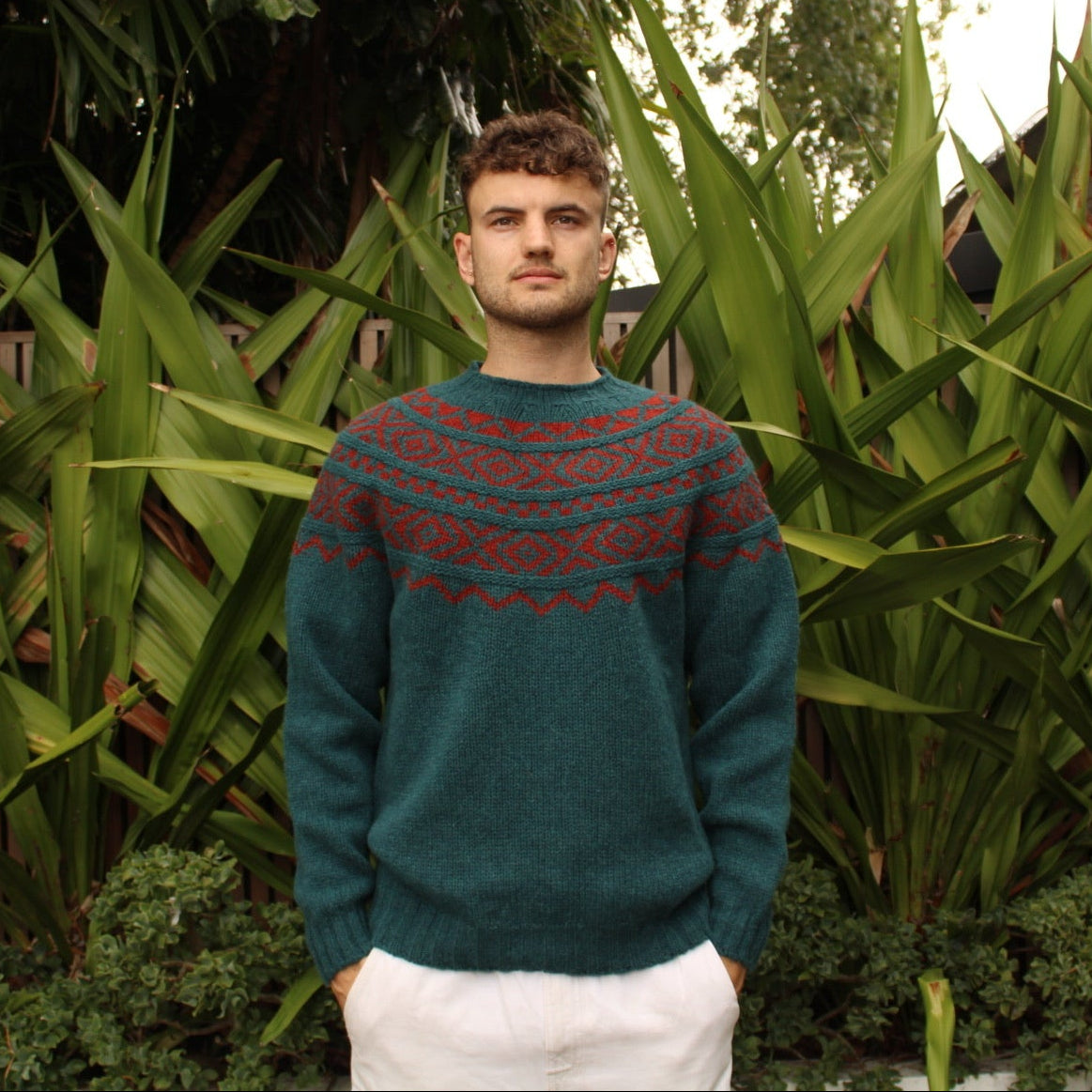 Man wearing the Shetland wool Fairisle Sweater in Tempest and Madder by Harley of Scotland