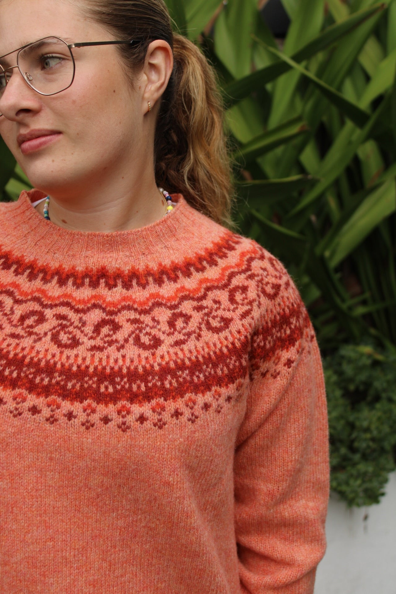 Woman wearing the Pretty Fairisle jumper by Harley of Scotland in orange Parfait