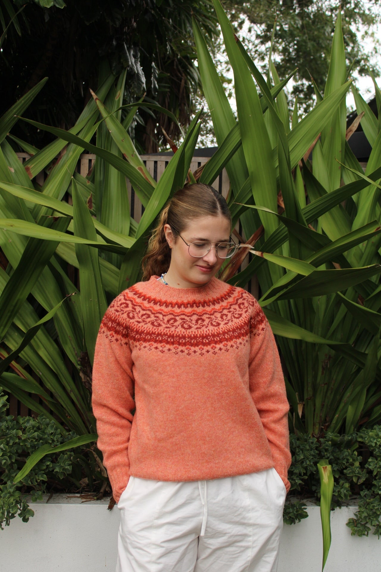 Woman wearing the Woollen Fairisle jumper by Harley of Scotland in orange Parfait