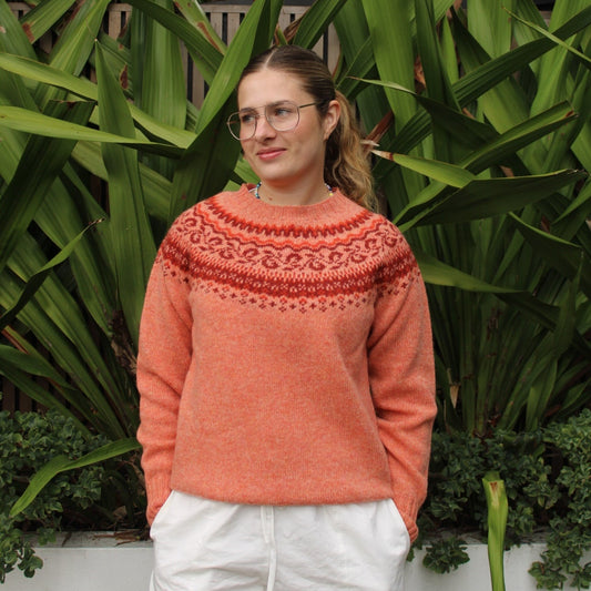 Woman wearing the Pretty Fairisle jumper by Harley of Scotland in orange Parfait