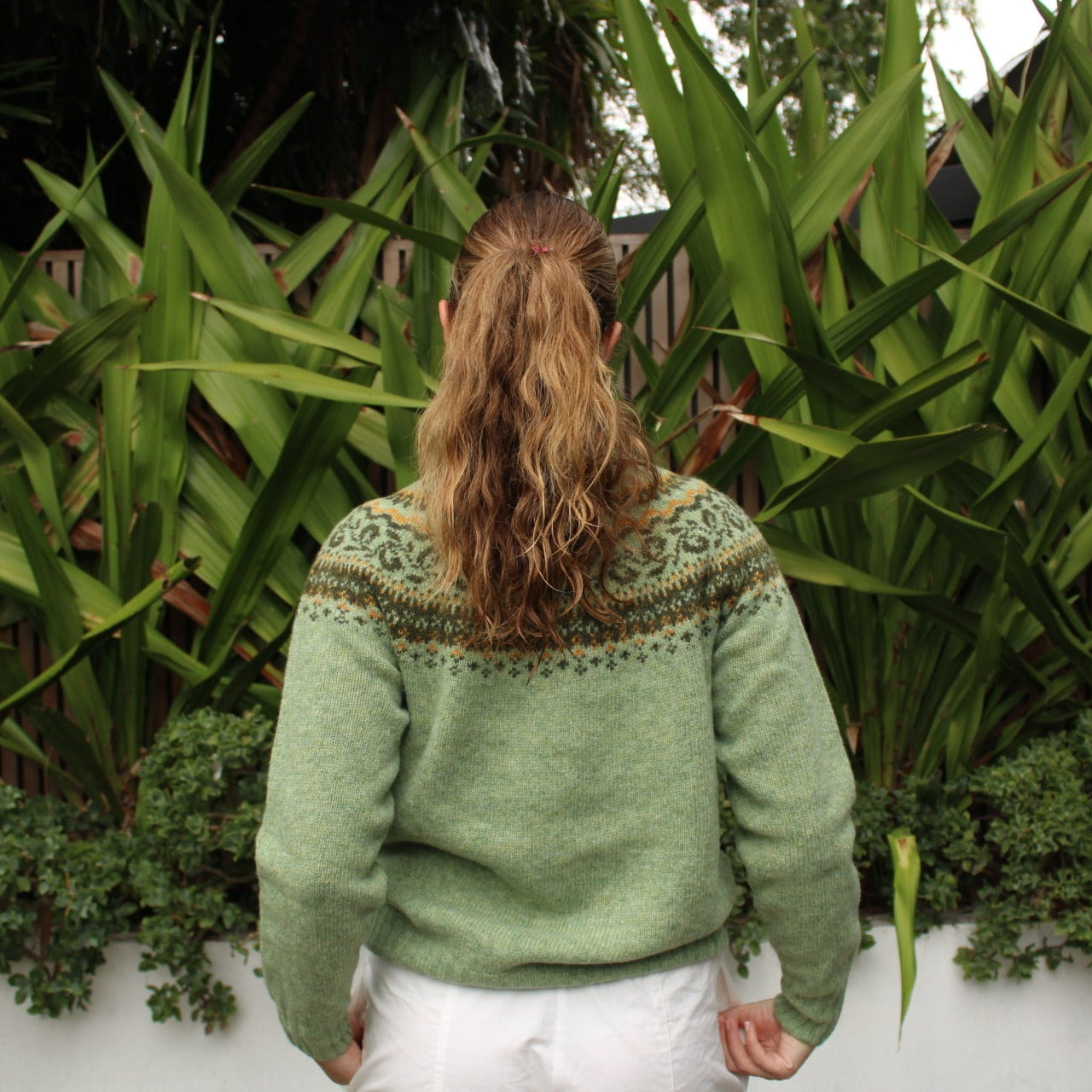 Woman wearing the Harley of Scotland woollen Fairisle Jumper in Sage green