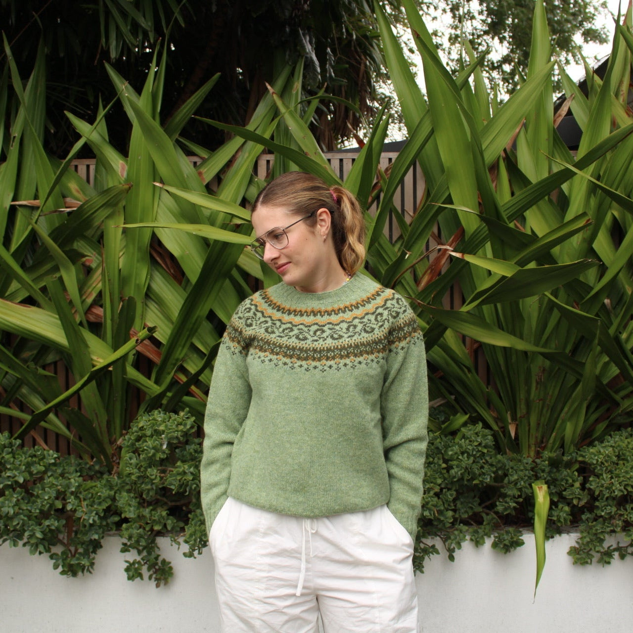 Woman wearing the Harley of Scotland wool Fairisle Jumper in Sage green