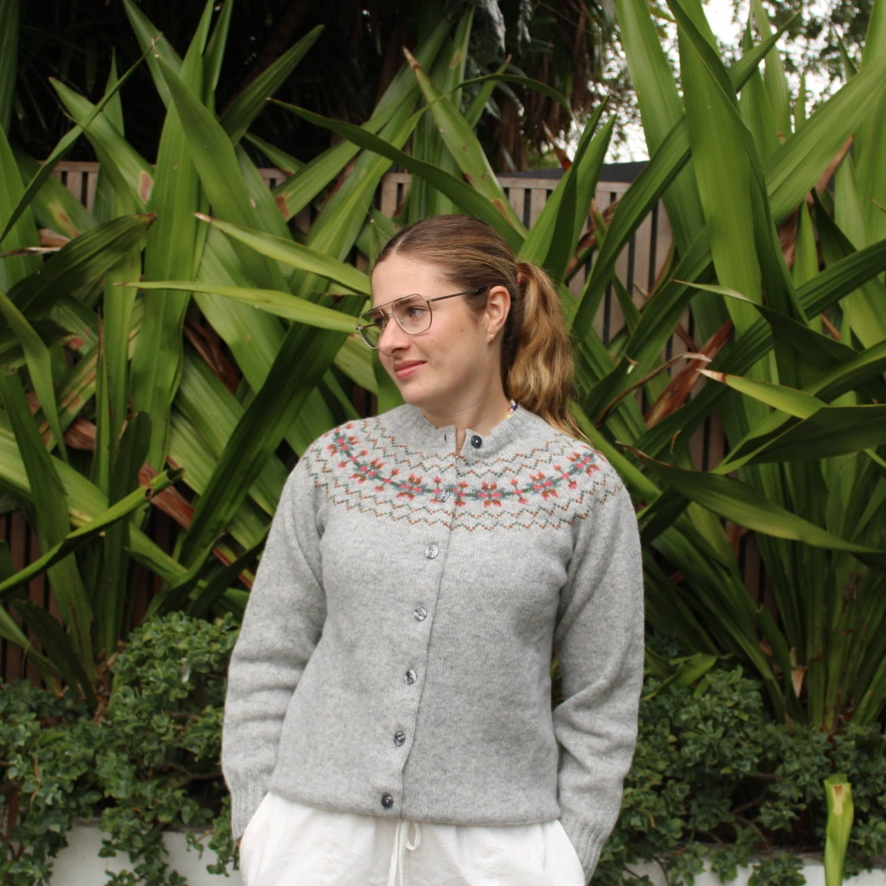 Woman wearing the wool Snowflake Fairisle Cardigan in Silver by Harley of Scotland