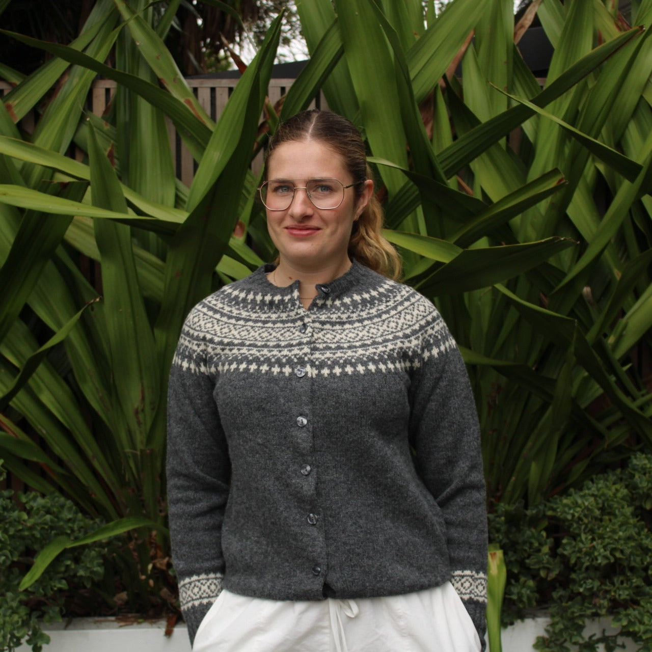 Woman wearing the Two Tone wool Fairisle Cardigan by Harley of Scotland in Basalt and Vanilla