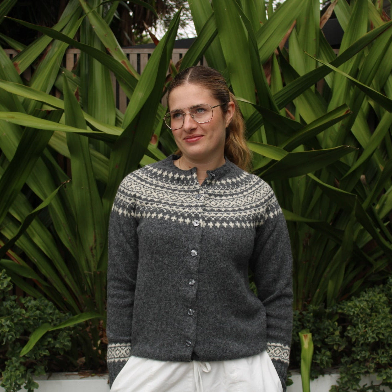 Woman wearing the Two Tone wool Fairisle Cardigan by Harley of Scotland in Basalt and Vanilla