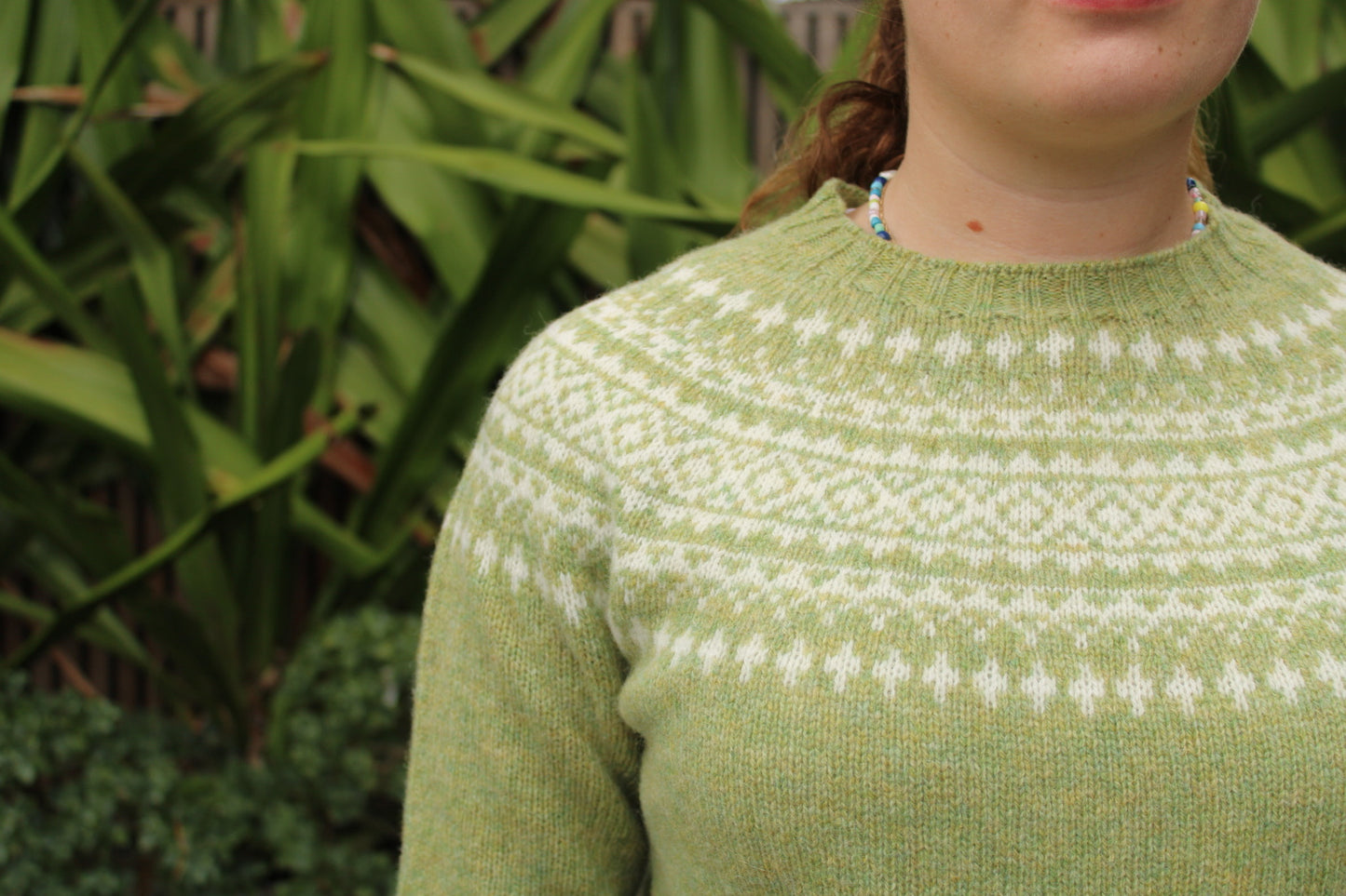 Close up of Fairisle knitted jumper in green and white