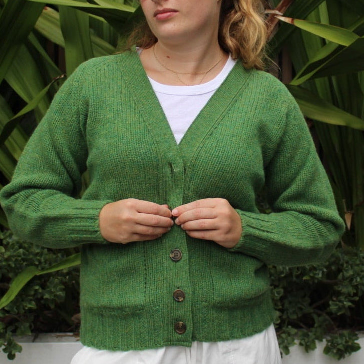 Woman wearing the Vee woollen Cardigan by Harley of Scotland in Blaize green