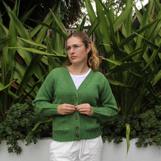 Woman wearing the Vee woollen Cardigan by Harley of Scotland in Blaize green