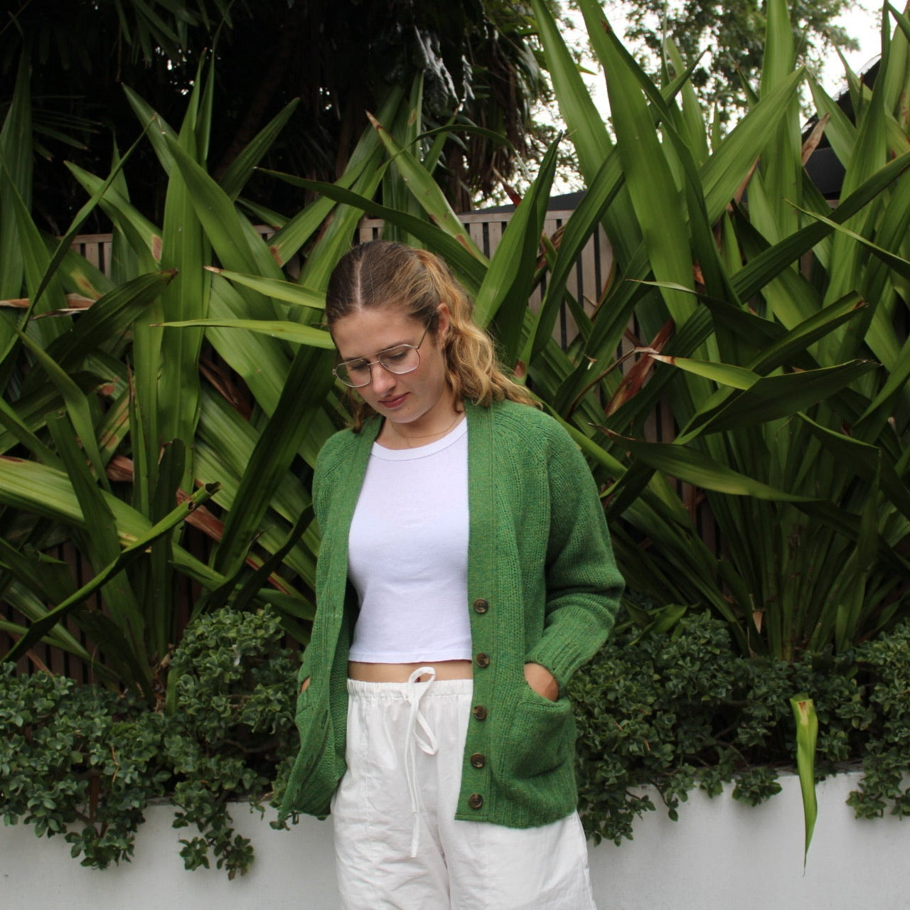 Woman wearing the Vee woollen Cardigan by Harley of Scotland in Blaize green