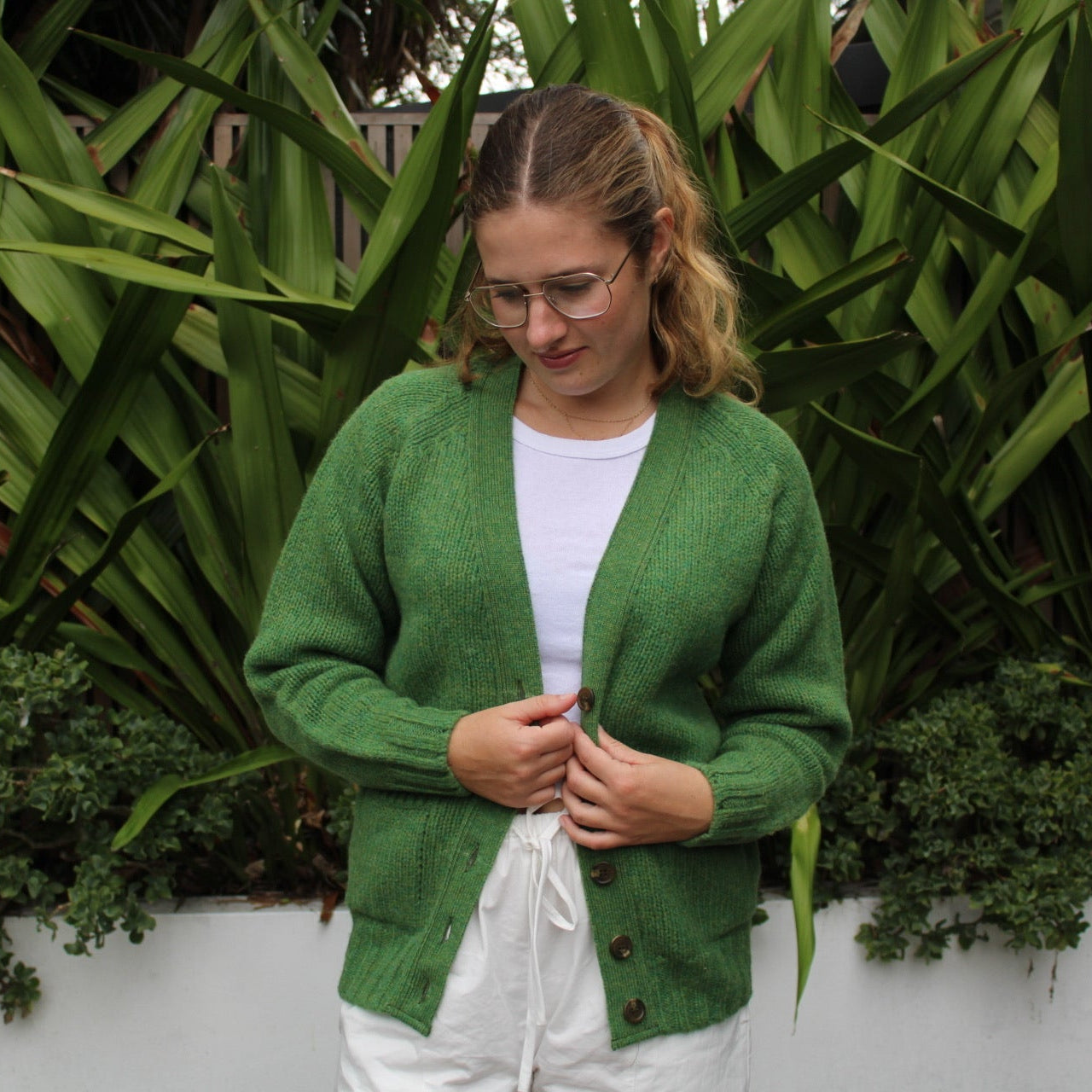 Woman wearing the Vee woollen Cardigan by Harley of Scotland in Blaize green
