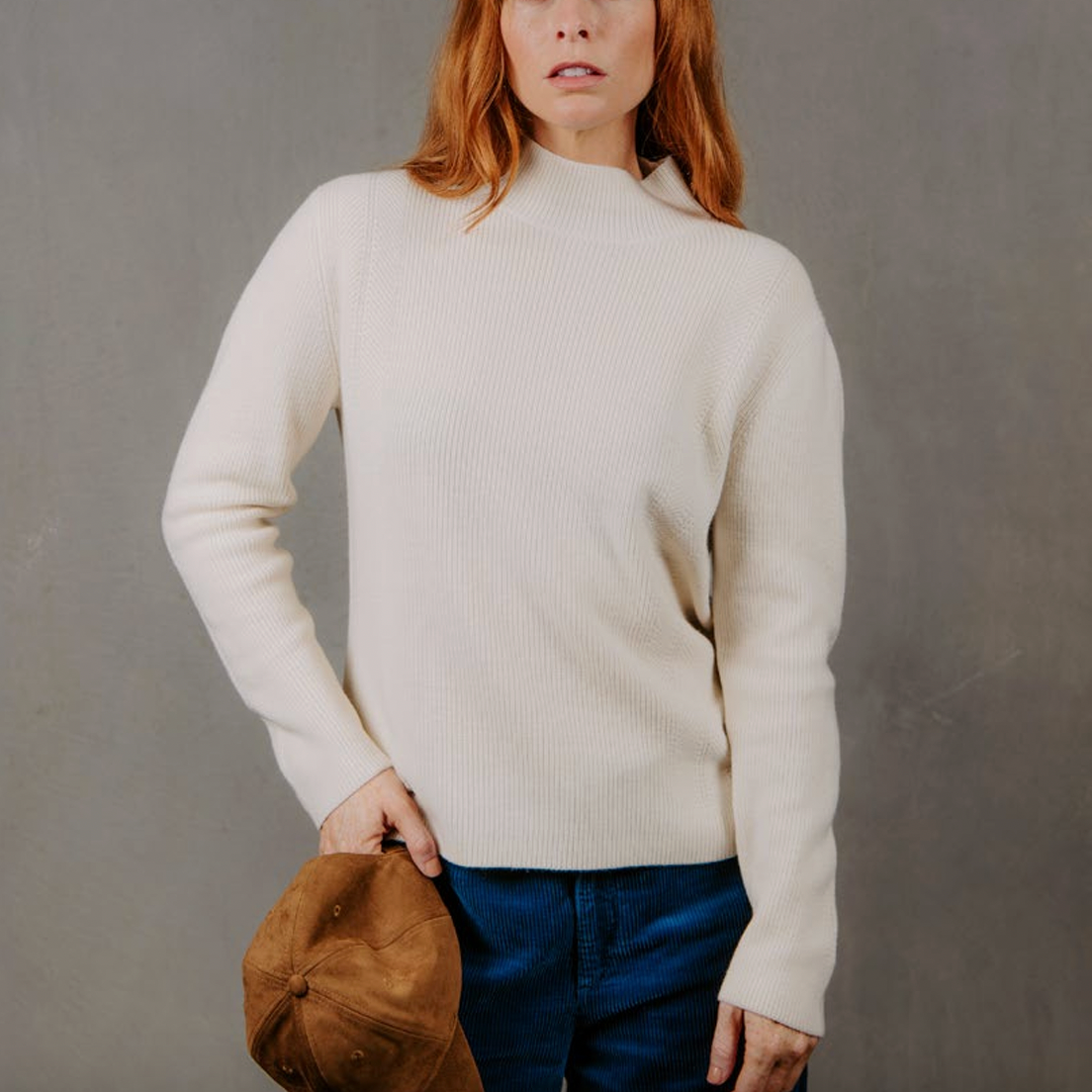 Woman wearing the High Crew Rib Jumper by Bridge and Lord in Ivory white