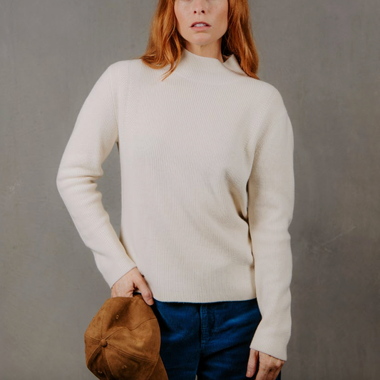 Woman wearing the High Crew Rib Jumper by Bridge and Lord in Ivory white