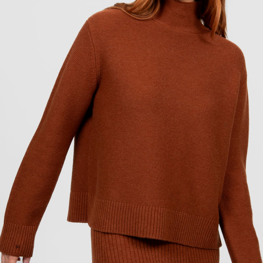 Woman wearing the Bridge and Lord Links Merino Pullover in Cognac