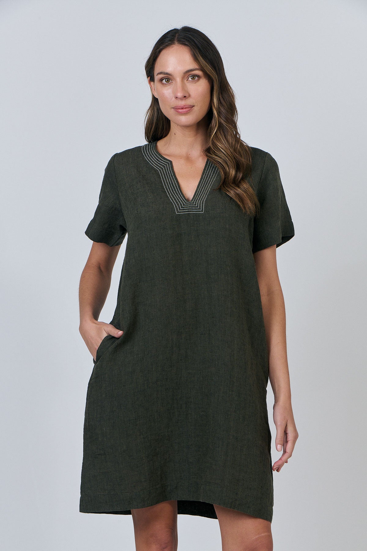 Woman wearing Naturals by O&J's Vee Stitch Linen Dress in Licorice green