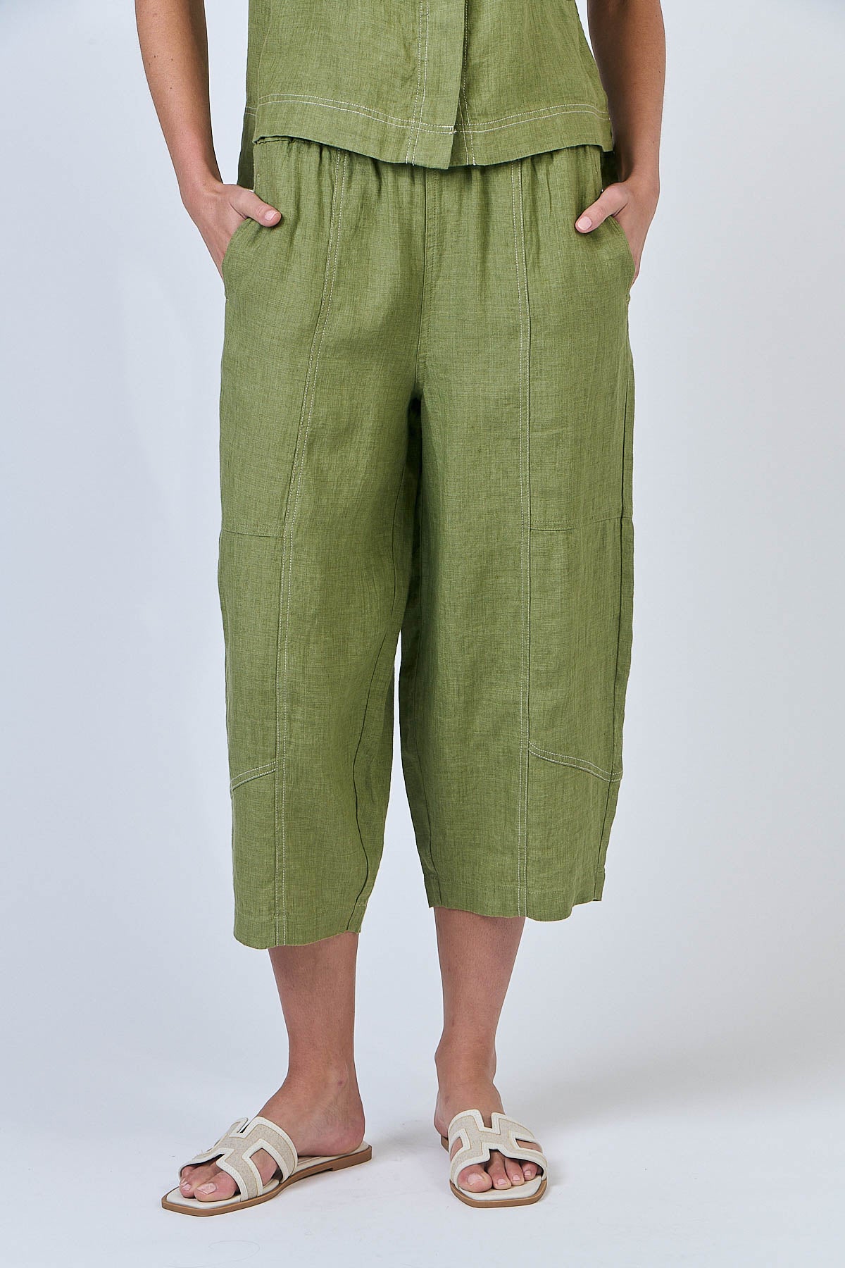 Woman wearing Naturals by O&J's Cropped Wide Linen Pants in Moss