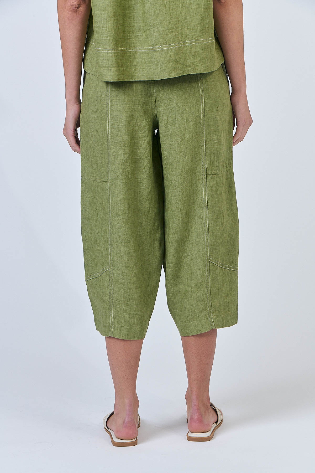 Woman wearing Naturals by O&J's Cropped Wide Linen Pants in Moss