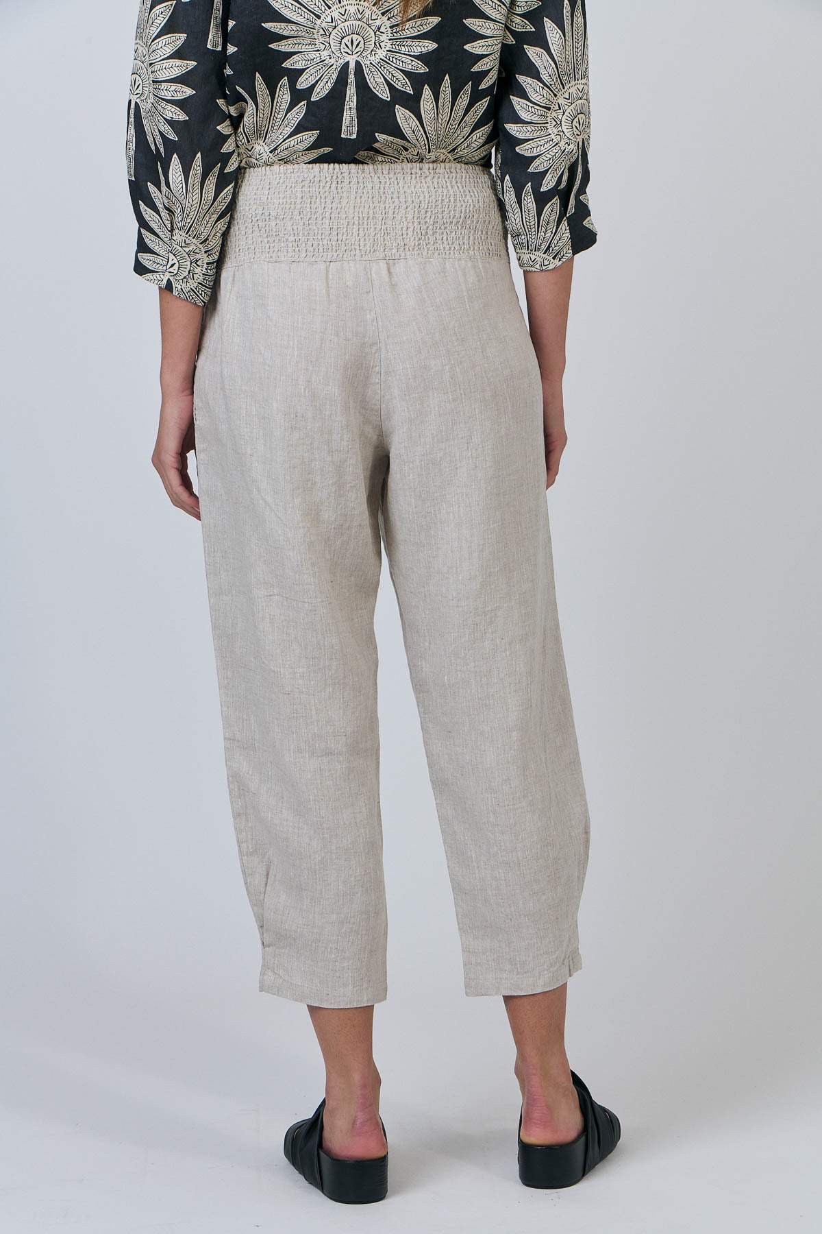 Woman wearing the Cropped Linen Pants by Naturals by O&J in Sand