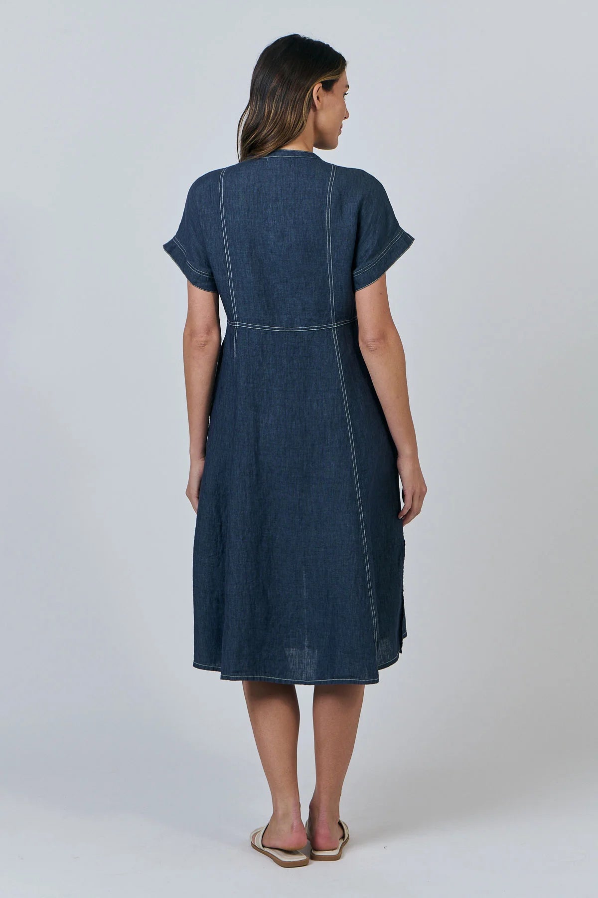 Woman with wearing the Contrast Stitch Linen Dress in denim Poseidon 