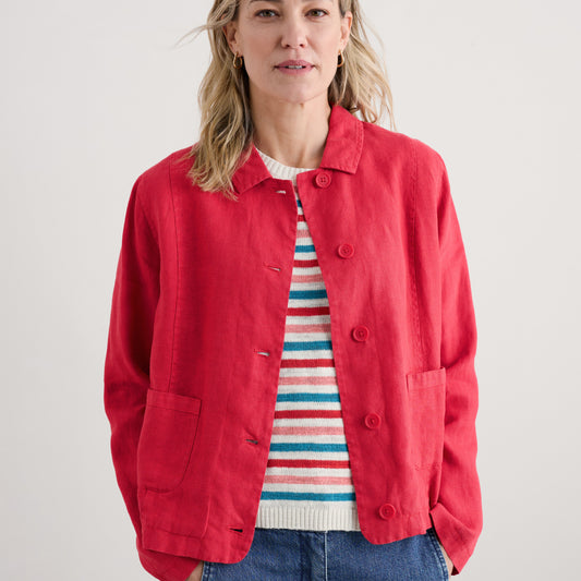 Woman wearing The Arame Linen Jacket by SEASALT in Raspberry red