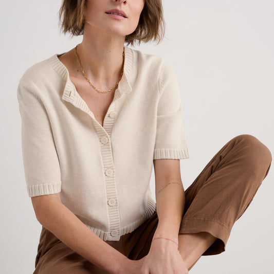Woman wearing the Gillan Creek Cardigan in Chalk beige by SEASALT