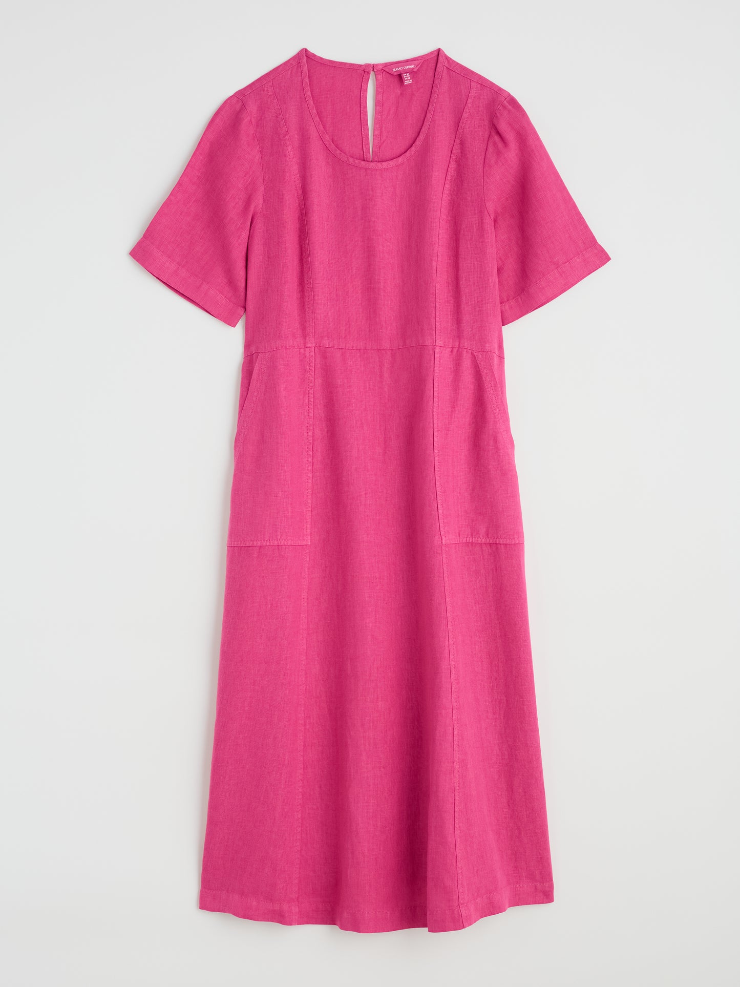 Flat lay of Grass Wave Linen Dress in Tulip pink by SEASALT