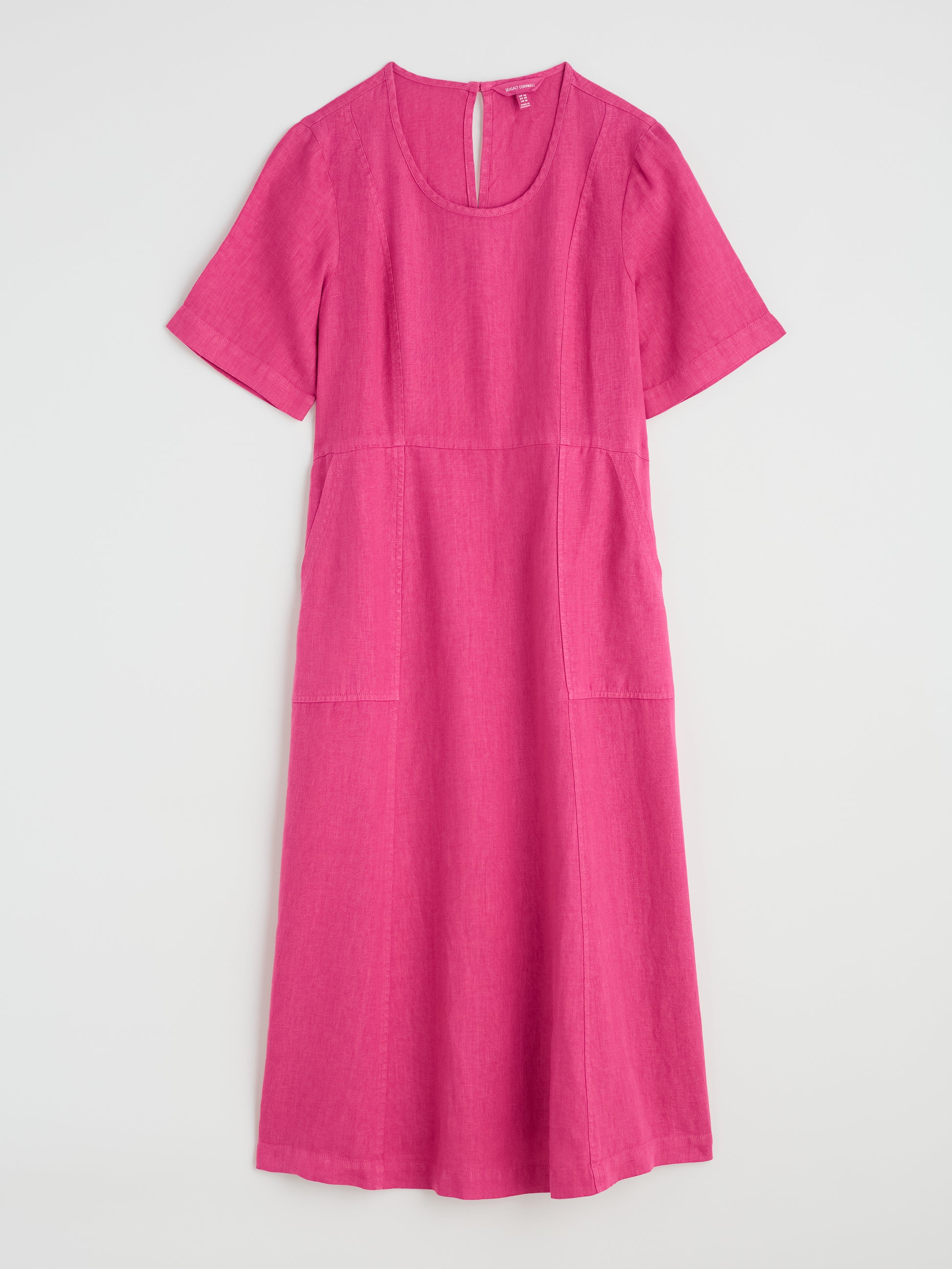 Flat lay of Grass Wave Linen Dress in Tulip pink by SEASALT
