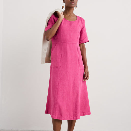 Woman wearing the Grass Wave Linen Dress in Tulip pink by SEASALT
