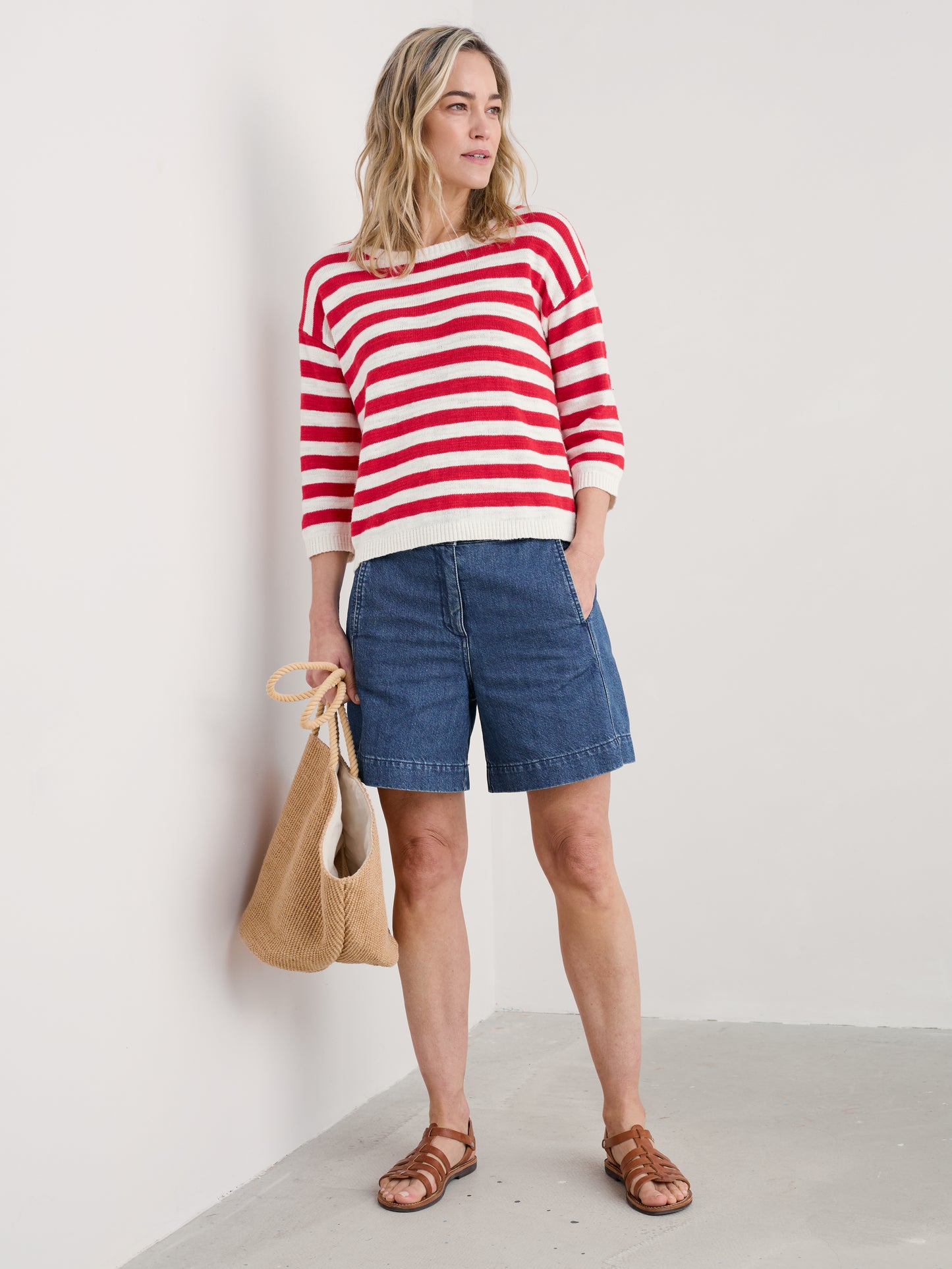 Woman wearing the Knavock Striped Jumper by SEASALT in Cornish Chalk Scarlet