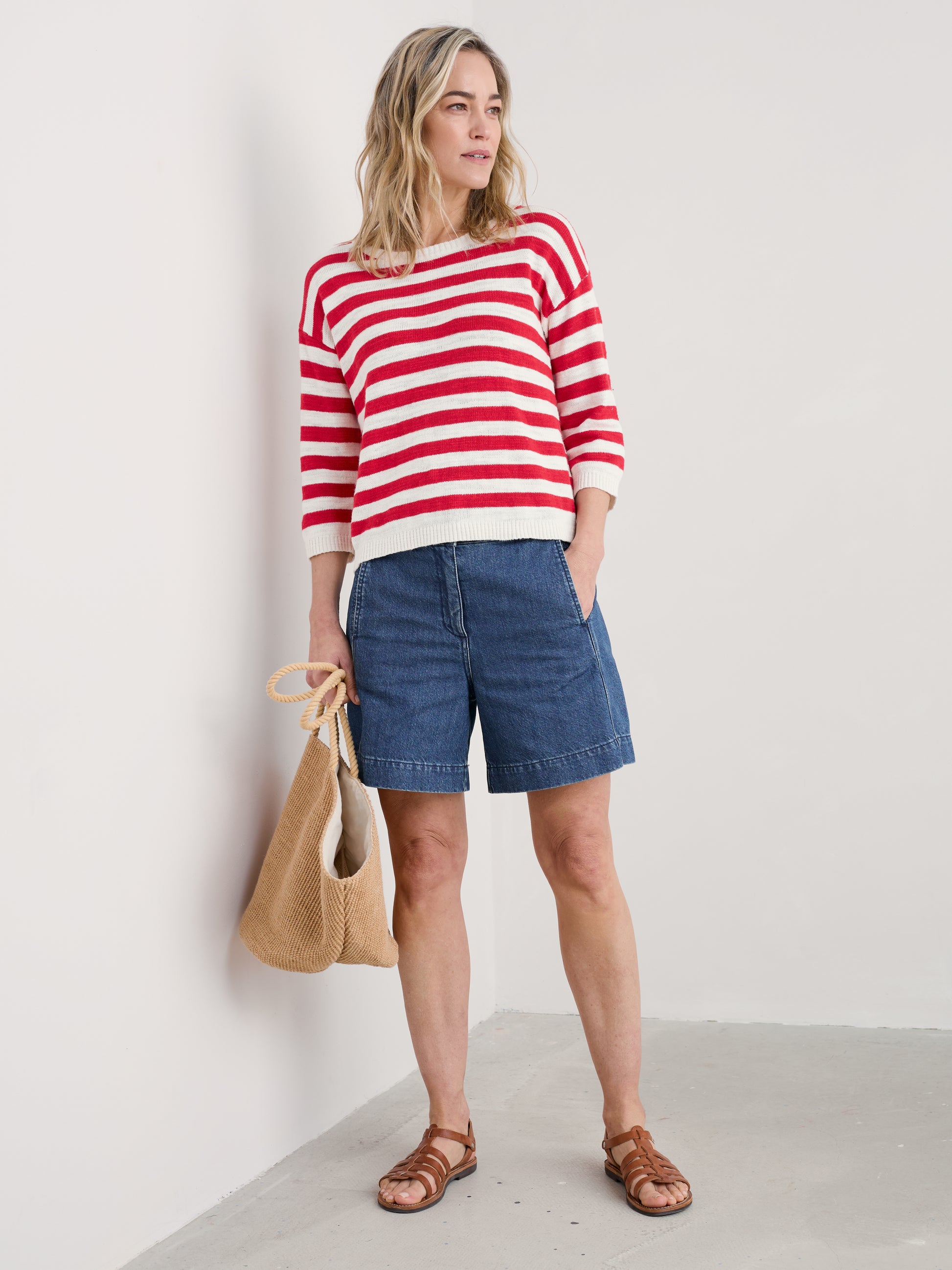 Woman wearing the Knavock Striped Jumper by SEASALT in Cornish Chalk Scarlet