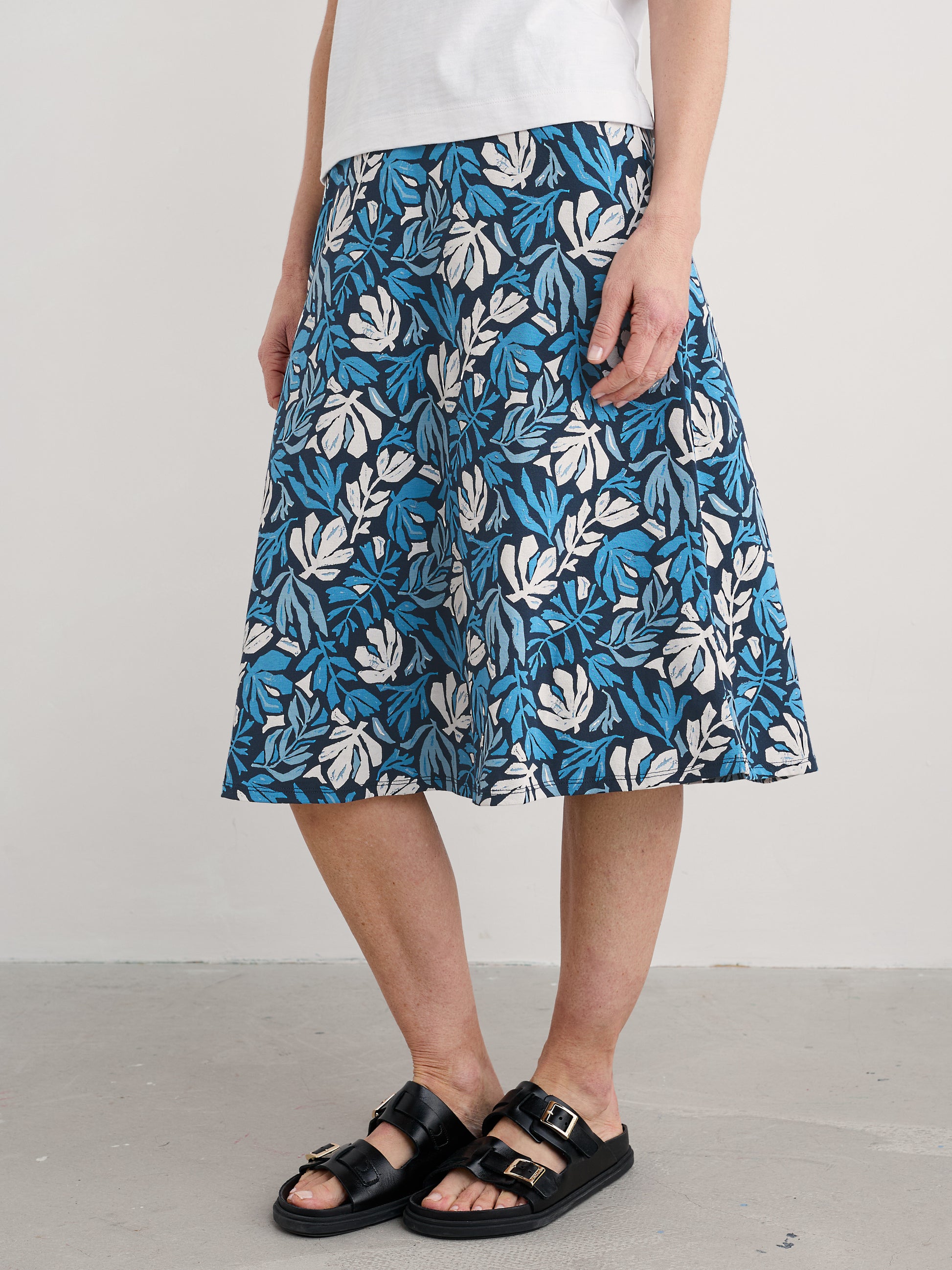 Woman wearing the Rose cotton midi Skirt by SEASALT in Cut Out Seaweed Maritime blue