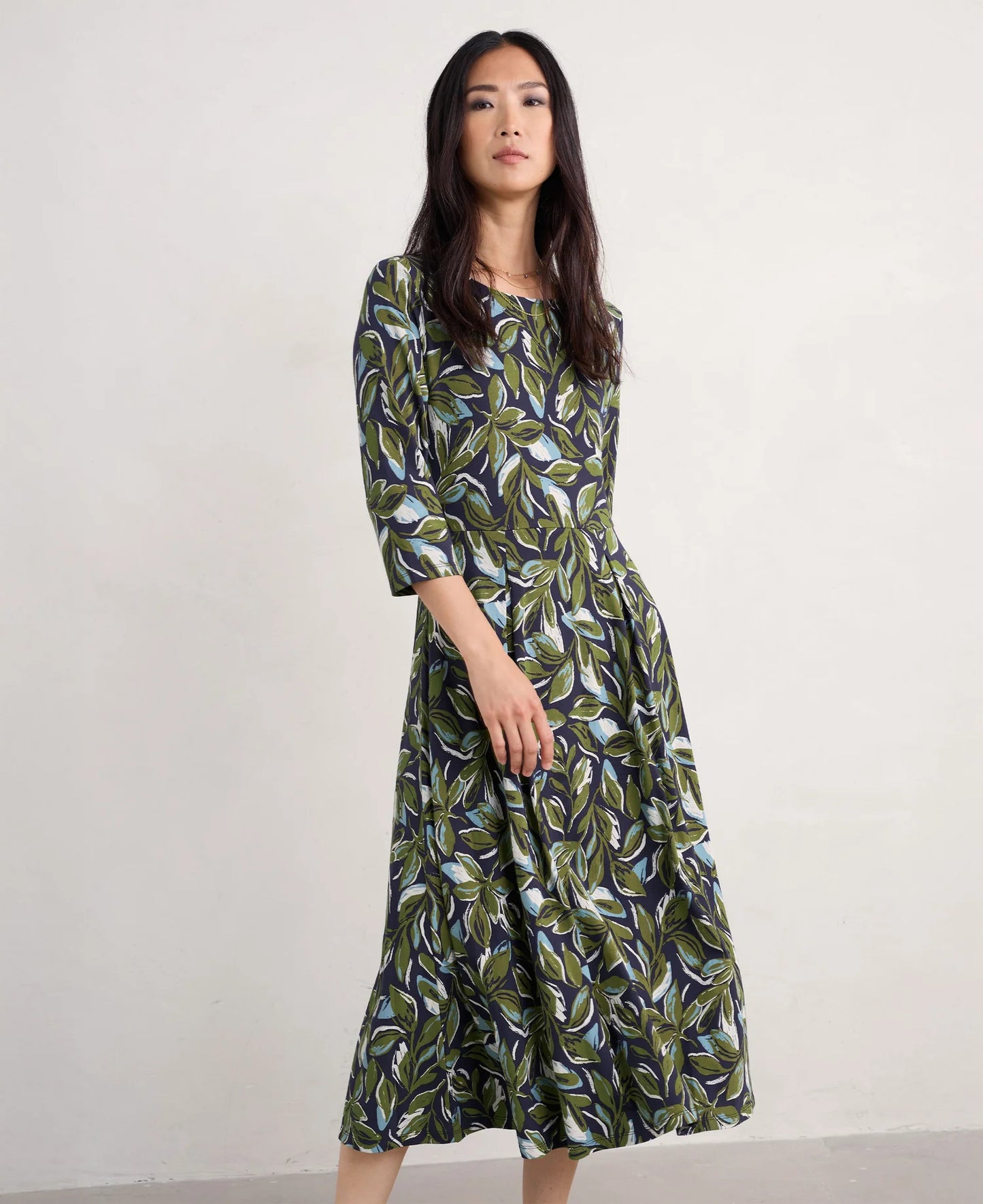 Woman wearing the Wild Bouquet cotton Dress by SEASALT in green Leaves