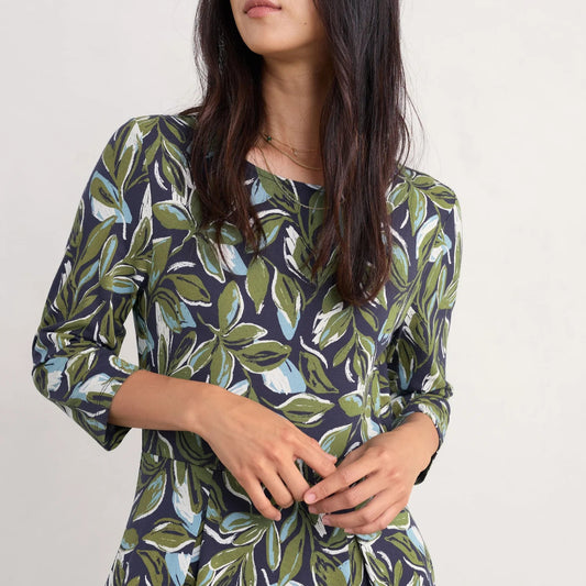 Woman wearing the Wild Bouquet midi Dress by SEASALT in green Leaves