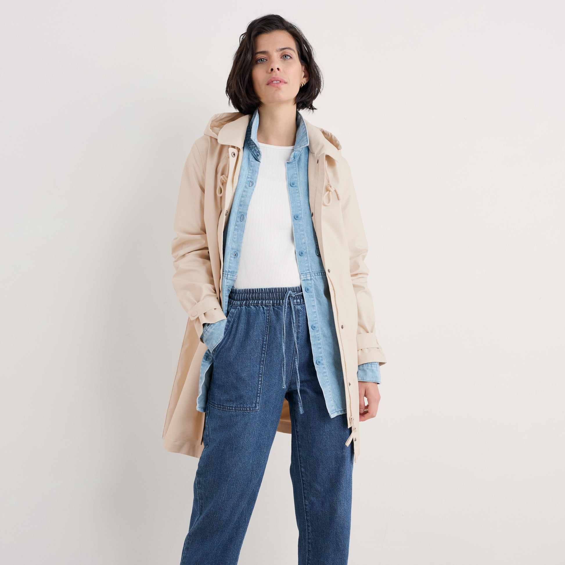 Woman wearing the Rainproof Cloudburst Mac in Limestone beige by SEASALT