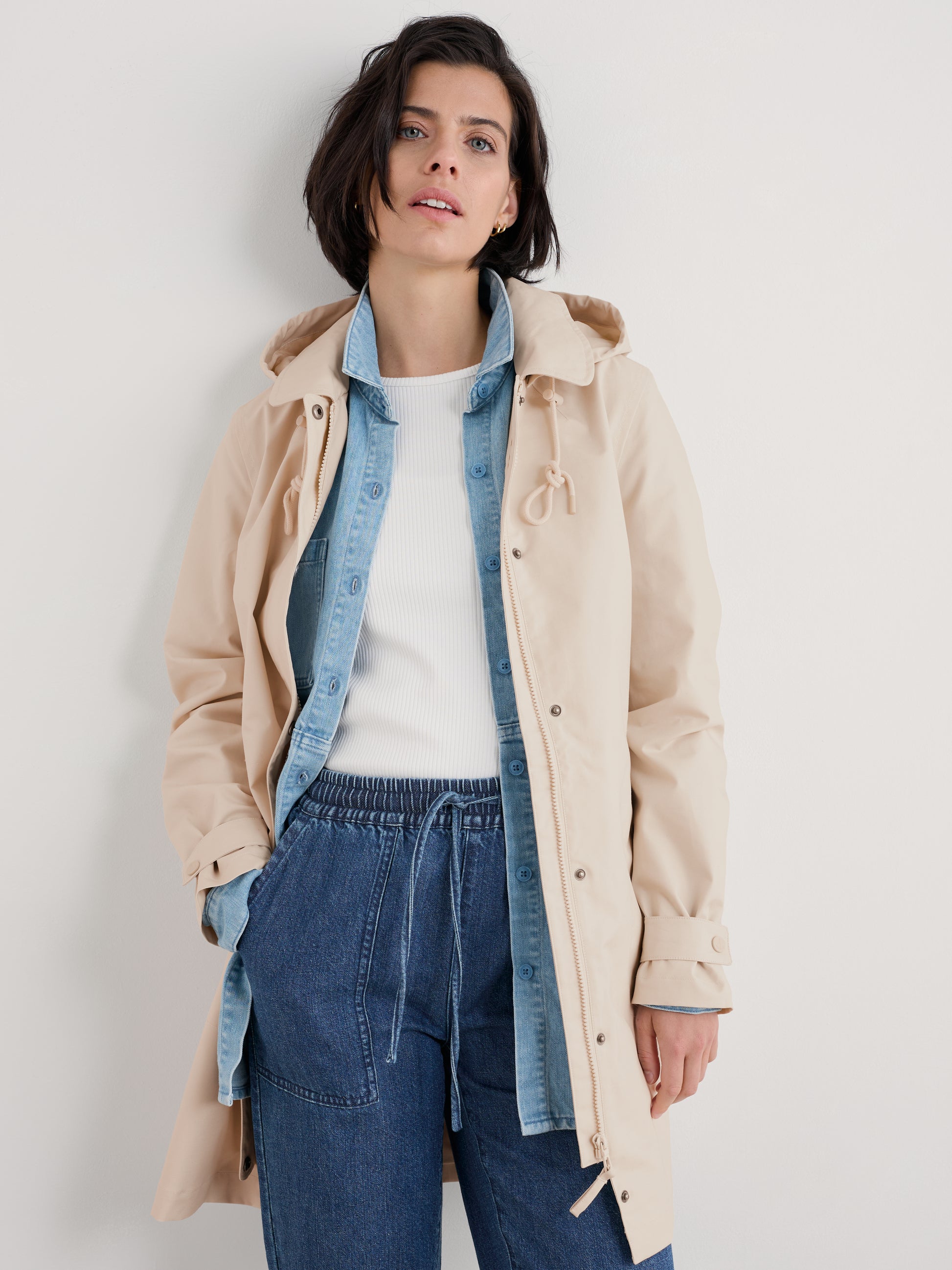 Woman wearing The Cloudburst Mac Rainjacket in Limestone by SEASALT for women